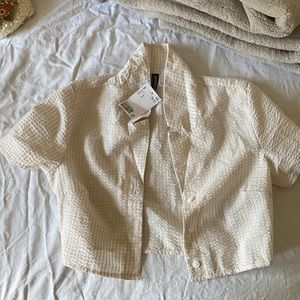 off-white cropped button up shirt.